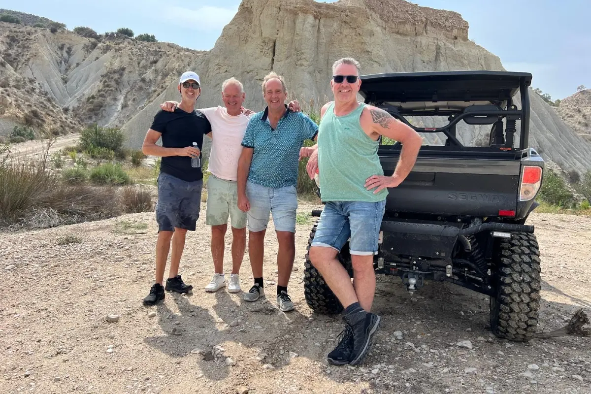 Friends posing in front of a Segway ATV vehicle U10 crew with a tour with Hondon Events Spain